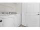 Laundry room featuring a Whirlpool washer and dryer, a wire shelf, and a white door at 2483 Morlynn Dr., Myrtle Beach, SC 29577
