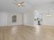 Open living area with wood-look floors and views into kitchen with granite counters and white cabinetry at 2483 Morlynn Dr., Myrtle Beach, SC 29577