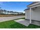 New backyard with a concrete patio space, lush green grass, and beautiful views at 2582 Cottonwood Dr., Loris, SC 29569