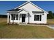 Charming single-story home with a welcoming front porch, black shutters, and new landscaping at 2582 Cottonwood Dr., Loris, SC 29569