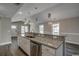 Open kitchen design with granite countertop island, stainless steel appliances, and modern pendant lights at 2582 Cottonwood Dr., Loris, SC 29569