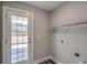 Functional laundry area with wood-look flooring and outdoor access at 2582 Cottonwood Dr., Loris, SC 29569