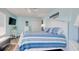 Relaxing bedroom with a queen bed, soft blue walls, and a peaceful coastal decor theme at 300 Shorehaven Dr. # A4, North Myrtle Beach, SC 29582
