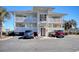 The exterior of a condo building features multiple balconies with white railings and convenient parking at 300 Shorehaven Dr. # A4, North Myrtle Beach, SC 29582