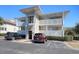 Inviting condo featuring multiple balconies with white railings and convenient parking spaces at 300 Shorehaven Dr. # A4, North Myrtle Beach, SC 29582