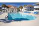 Community pool surrounded by lounge chairs and palm trees at 300 Shorehaven Dr. # A4, North Myrtle Beach, SC 29582