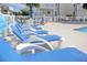 Community pool deck with blue lounge chairs and tropical plants at 300 Shorehaven Dr. # A4, North Myrtle Beach, SC 29582