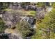 Overhead view of a landscaped property, with an intricate roof design, surrounded by mature trees at 3148 River Bluff Ln., Little River, SC 29566