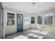 Sunroom featuring neutral walls and floor with multiple windows and a blue exterior door at 3148 River Bluff Ln., Little River, SC 29566