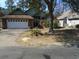 Charming single-story home featuring a brick facade, attached garage, and mature landscaping at 3158 River Bluff Ln., Little River, SC 29566