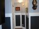 View of hallway featuring paneled walls, hardwood floors, and decorative accents at 3158 River Bluff Ln., Little River, SC 29566