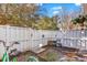 View of the fenced backyard showcasing a small tricycle, landscaping, and white fencing at 3557 Chestnut Dr. # 3557, Myrtle Beach, SC 29577