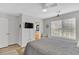 Cozy bedroom features a gray queen bed, ceiling fan, and an ensuite bathroom at 3557 Chestnut Dr. # 3557, Myrtle Beach, SC 29577