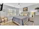 Bright bedroom features a queen bed, ceiling fan and neutral walls with a window for natural light at 3557 Chestnut Dr. # 3557, Myrtle Beach, SC 29577