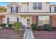 Inviting front entrance of a two story home with a brick accent wall and well maintained landscaping at 3557 Chestnut Dr. # 3557, Myrtle Beach, SC 29577