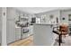 Renovated kitchen features gray cabinets, stainless steel appliances, and an open layout with a breakfast bar at 3557 Chestnut Dr. # 3557, Myrtle Beach, SC 29577