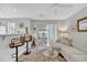 View of a sunlit living room with a breakfast bar, ceiling fan, and door to a patio at 3557 Chestnut Dr. # 3557, Myrtle Beach, SC 29577