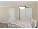 Bright dining area with a white table, chairs, and decorative light fixture creates a pleasant eating space at 3762 Citation Way # 1013, Myrtle Beach, SC 29577
