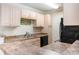 Functional kitchen featuring light wood cabinets, laminate countertops, and black appliances offers practicality at 3762 Citation Way # 1013, Myrtle Beach, SC 29577
