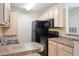 Well-equipped kitchen showcasing ample cabinet space and modern black appliances for culinary convenience at 3762 Citation Way # 1013, Myrtle Beach, SC 29577