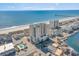 Aerial view of a beachfront community with pool, ocean, and pier in the background at 4103 N Ocean Blvd. # 207, North Myrtle Beach, SC 29582