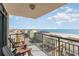 Balcony view with two Adirondack chairs overlooking the ocean, beach, and street at 4103 N Ocean Blvd. # 207, North Myrtle Beach, SC 29582