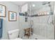 Clean and contemporary bathroom featuring blue accents, a glass shower door, a shower bench, and white tiling at 4103 N Ocean Blvd. # 207, North Myrtle Beach, SC 29582