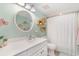 Bright bathroom featuring a single sink vanity, coastal decor, a round mirror, and a shower with a curtain at 4103 N Ocean Blvd. # 207, North Myrtle Beach, SC 29582