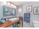 Nautical-themed bathroom featuring beachy decor, a wood vanity, and a bright mirror and sconce lighting at 4103 N Ocean Blvd. # 207, North Myrtle Beach, SC 29582