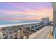 High-angle view of beach houses along the coast and scenic views of ocean under blue skies at 4103 N Ocean Blvd. # 207, North Myrtle Beach, SC 29582