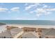 Expansive beach view from rooftop with ocean, sand, and nearby houses in sight at 4103 N Ocean Blvd. # 207, North Myrtle Beach, SC 29582