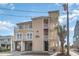 Charming beach condo exterior featuring a well-maintained lawn and coastal curb appeal at 4103 N Ocean Blvd. # 207, North Myrtle Beach, SC 29582