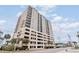 Attractive condo building featuring a parking garage and well-manicured landscaping at 4103 N Ocean Blvd. # 207, North Myrtle Beach, SC 29582