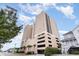 Condo building exterior, featuring a parking garage and tropical landscaping at 4103 N Ocean Blvd. # 207, North Myrtle Beach, SC 29582