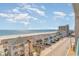 Beautiful view of the ocean from a balcony with beachfront homes and partly cloudy skies at 4103 N Ocean Blvd. # 207, North Myrtle Beach, SC 29582