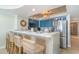 Kitchen with stainless steel appliances, tile floors, barstool seating, and ocean-themed decor at 4103 N Ocean Blvd. # 207, North Myrtle Beach, SC 29582