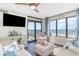 Comfortable living room with access to a balcony that overlooks a beautiful ocean view at 4103 N Ocean Blvd. # 207, North Myrtle Beach, SC 29582