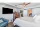 Comfortable main bedroom offering a large dresser and television, along with doors to the kitchen and primary bathroom at 4103 N Ocean Blvd. # 207, North Myrtle Beach, SC 29582