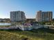 Aerial view of condos near water featuring outdoor dining and lounge areas at 415 Ocean Creek Dr. # 2202, Myrtle Beach, SC 29572
