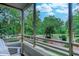 Exterior balcony with views of landscaped grounds and tree-lined street at 415 Ocean Creek Dr. # 2202, Myrtle Beach, SC 29572