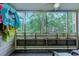Relaxing screened-in balcony with furniture, offering views of the complex and surrounding nature at 415 Ocean Creek Dr. # 2202, Myrtle Beach, SC 29572