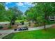 Scenic community view featuring lush greenery, a golf cart, and winding pathways under a bright, partly cloudy sky at 415 Ocean Creek Dr. # 2202, Myrtle Beach, SC 29572