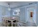 Cozy dining room featuring a wooden table set, modern lighting fixture, and an open view into the adjacent kitchen at 415 Ocean Creek Dr. # 2202, Myrtle Beach, SC 29572