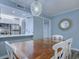 Charming dining area with an open kitchen view, featuring a wooden table, stylish light fixture, and unique wall decor at 415 Ocean Creek Dr. # 2202, Myrtle Beach, SC 29572