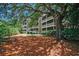 Exterior view of a multi-story building with screened porches surrounded by trees and landscaping at 415 Ocean Creek Dr. # 2202, Myrtle Beach, SC 29572