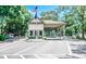 Entrance to a gated community featuring a guard house and lush greenery at 415 Ocean Creek Dr. # 2202, Myrtle Beach, SC 29572