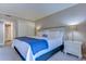 Serene main bedroom featuring a comfortable bed, soft lighting, and a view into the ensuite bathroom at 415 Ocean Creek Dr. # 2202, Myrtle Beach, SC 29572