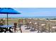 Breathtaking ocean views from the outdoor patio featuring comfortable seating and an umbrella at 415 Ocean Creek Dr. # 2202, Myrtle Beach, SC 29572