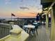 A view of the ocean and a stunning sunset from the outdoor patio with seating at dusk at 415 Ocean Creek Dr. # 2202, Myrtle Beach, SC 29572