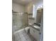 Modern bathroom featuring a glass-enclosed shower, granite vanity, and tiled floors at 4155 Hibiscus Dr. # 103, Little River, SC 29566